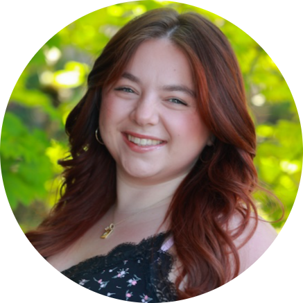 Smiling woman with auburn hair in natural outdoor setting